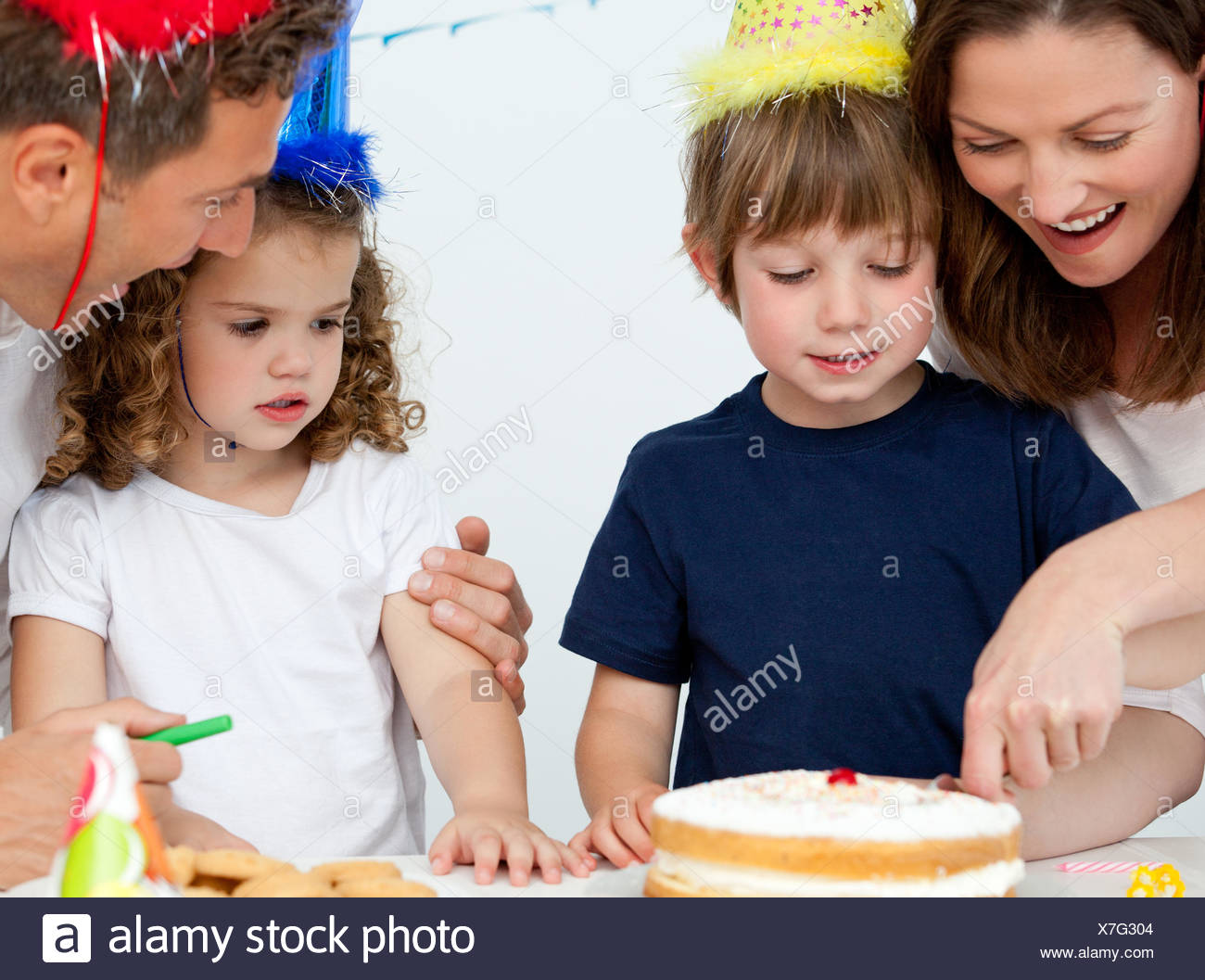 Mom And Son Cutting A Birthday Cake Together Stock Photo