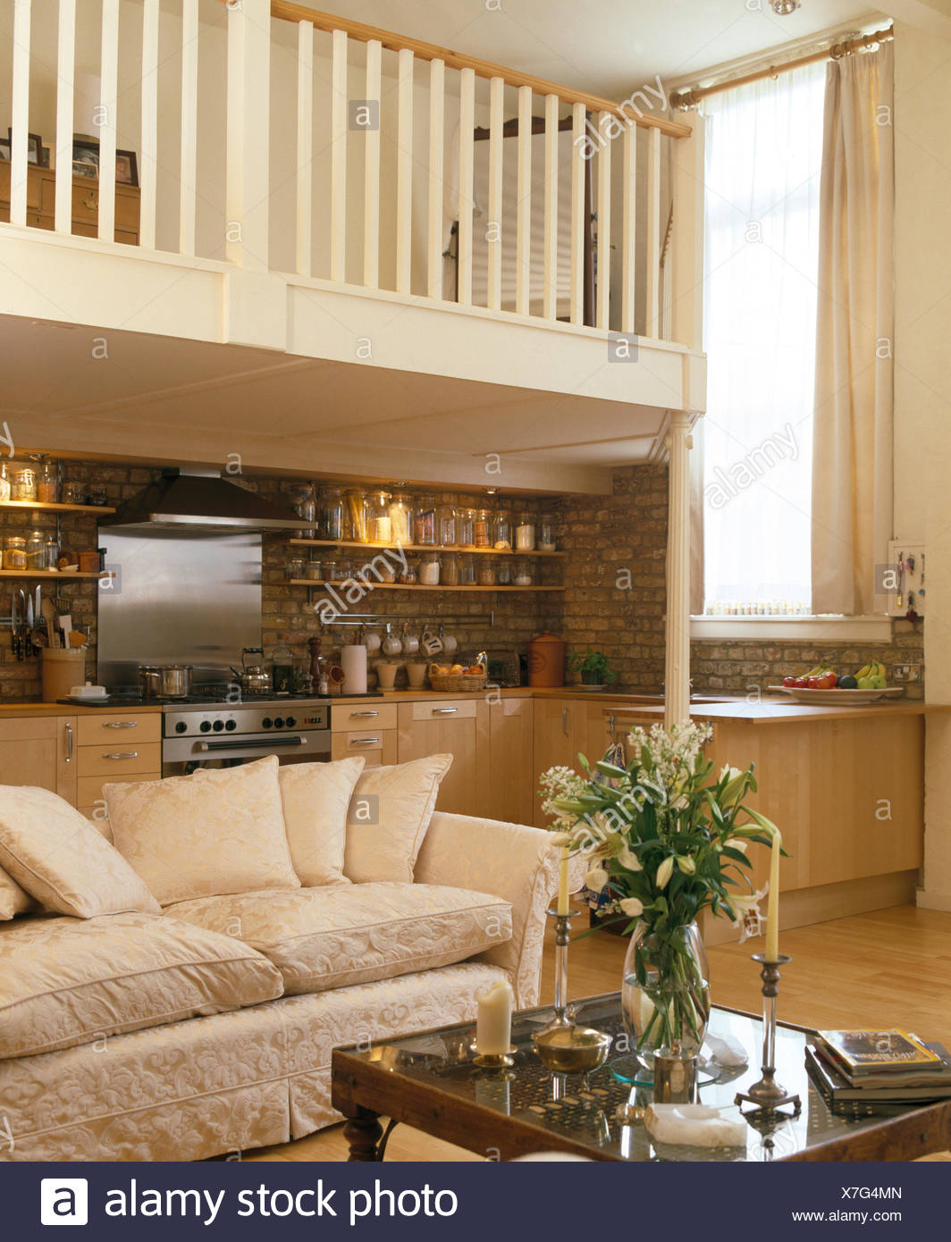 Cream Sofa Below Mezzanine Floor In Open Plan Living And Kitchen