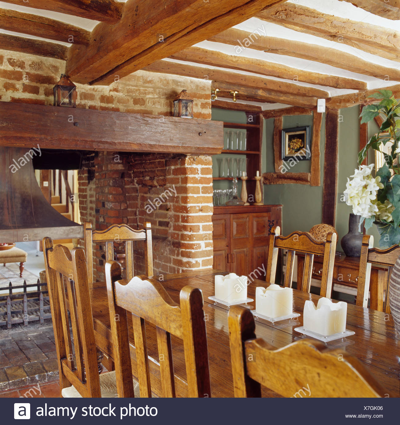 Wooden Chairs And Table In Beamed Cottage Dining Room With