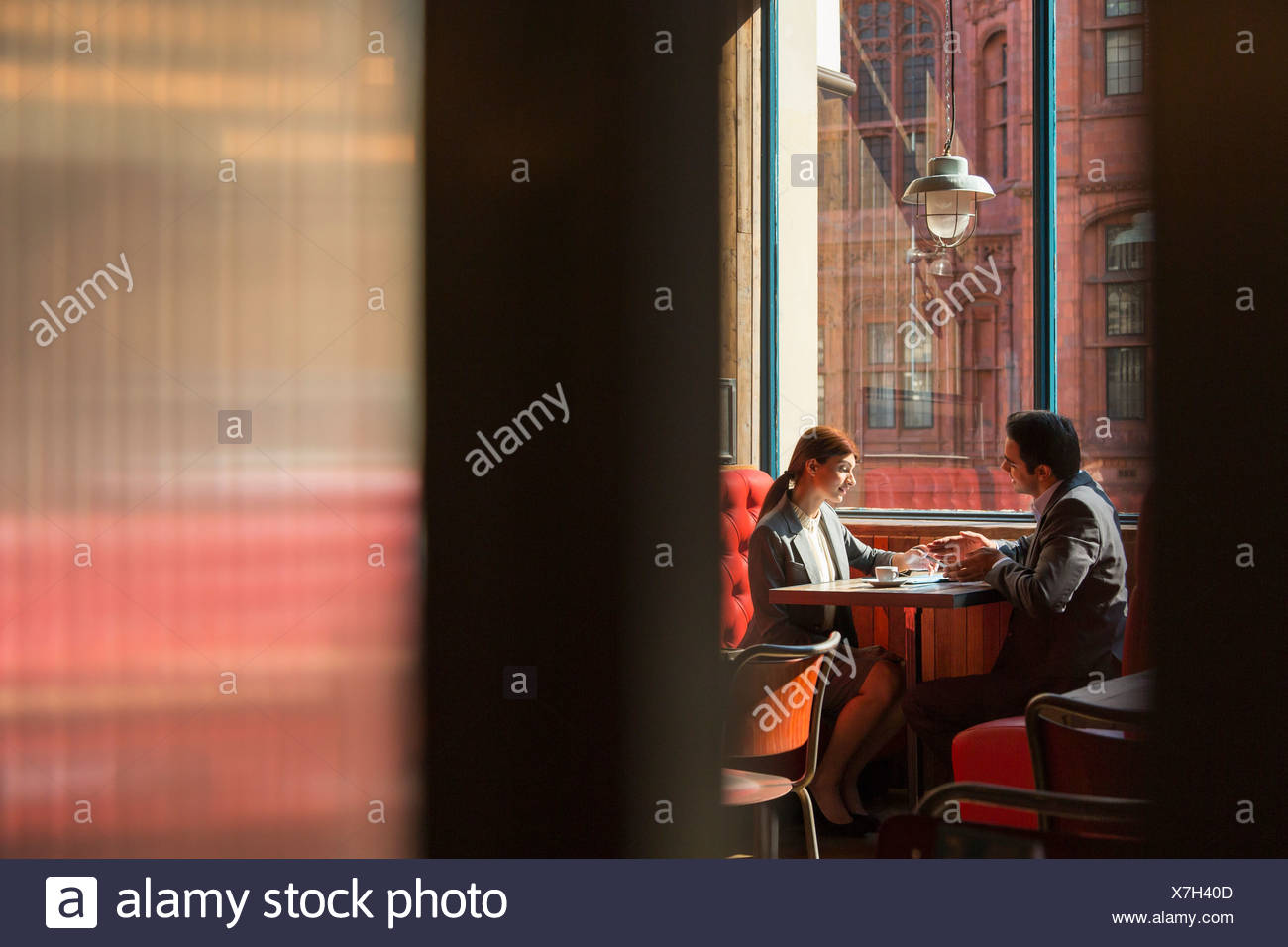 Couple Sitting In Restaurant Booth High Resolution Stock Photography