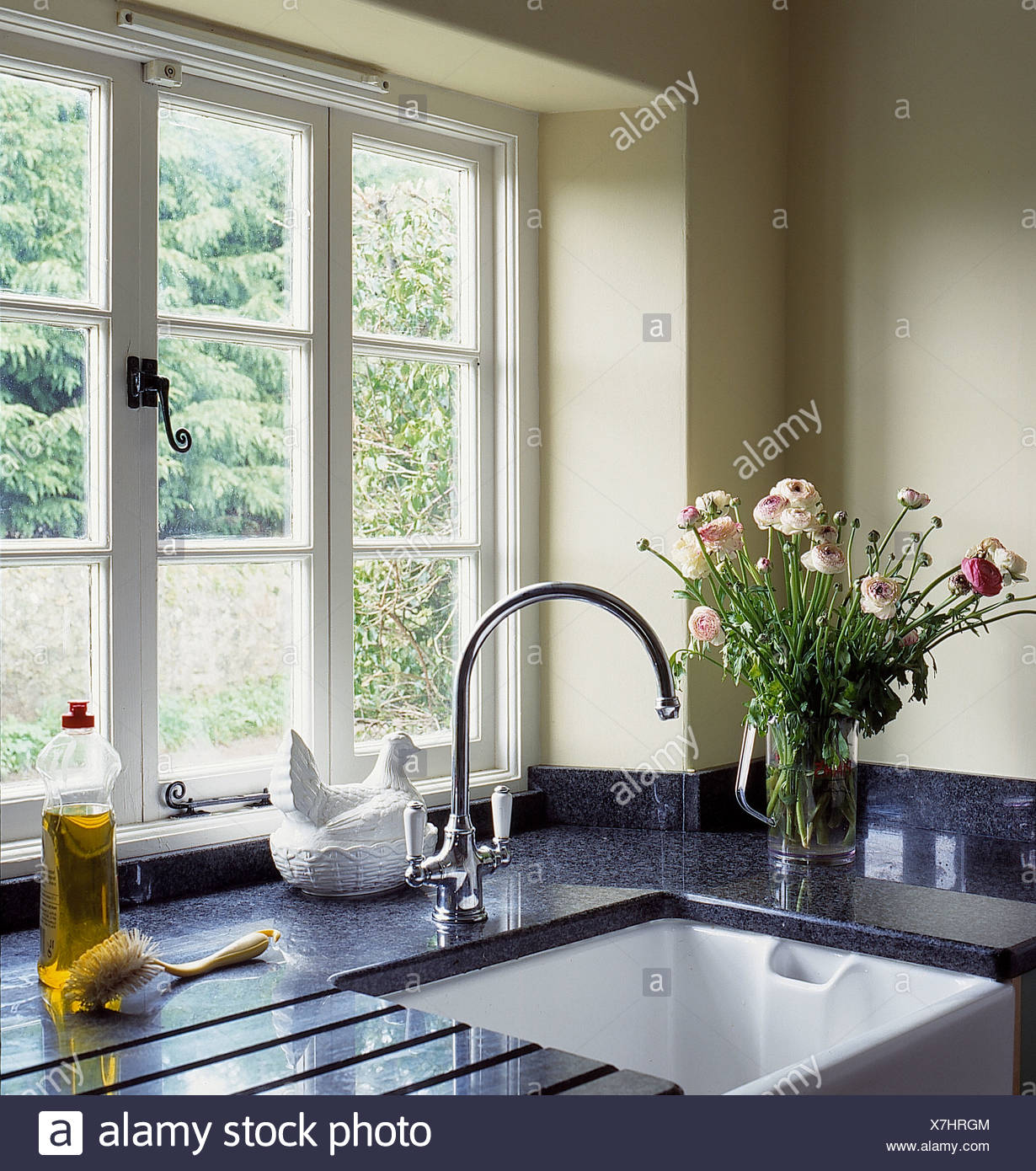 Window Above Belfast Sink With Chrome Tap In Cottage Kitchen