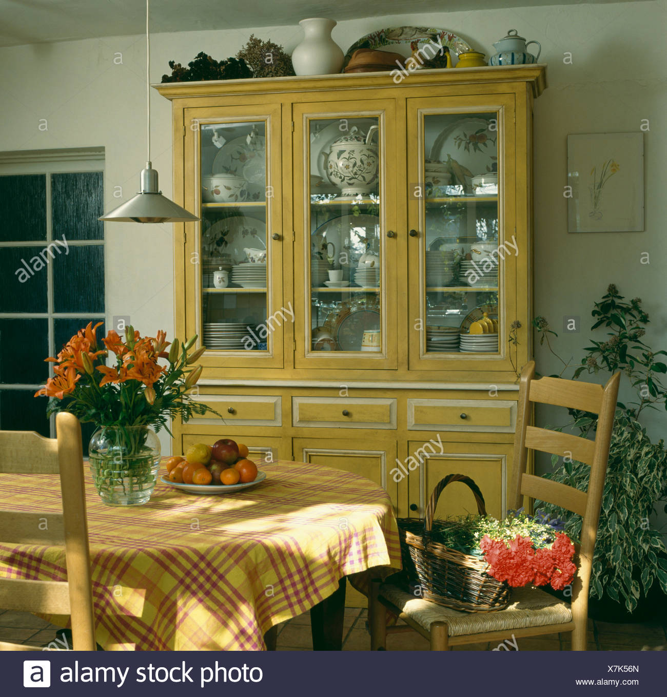 Painted Yellow Dresser With Glass Doors In Dining Room With