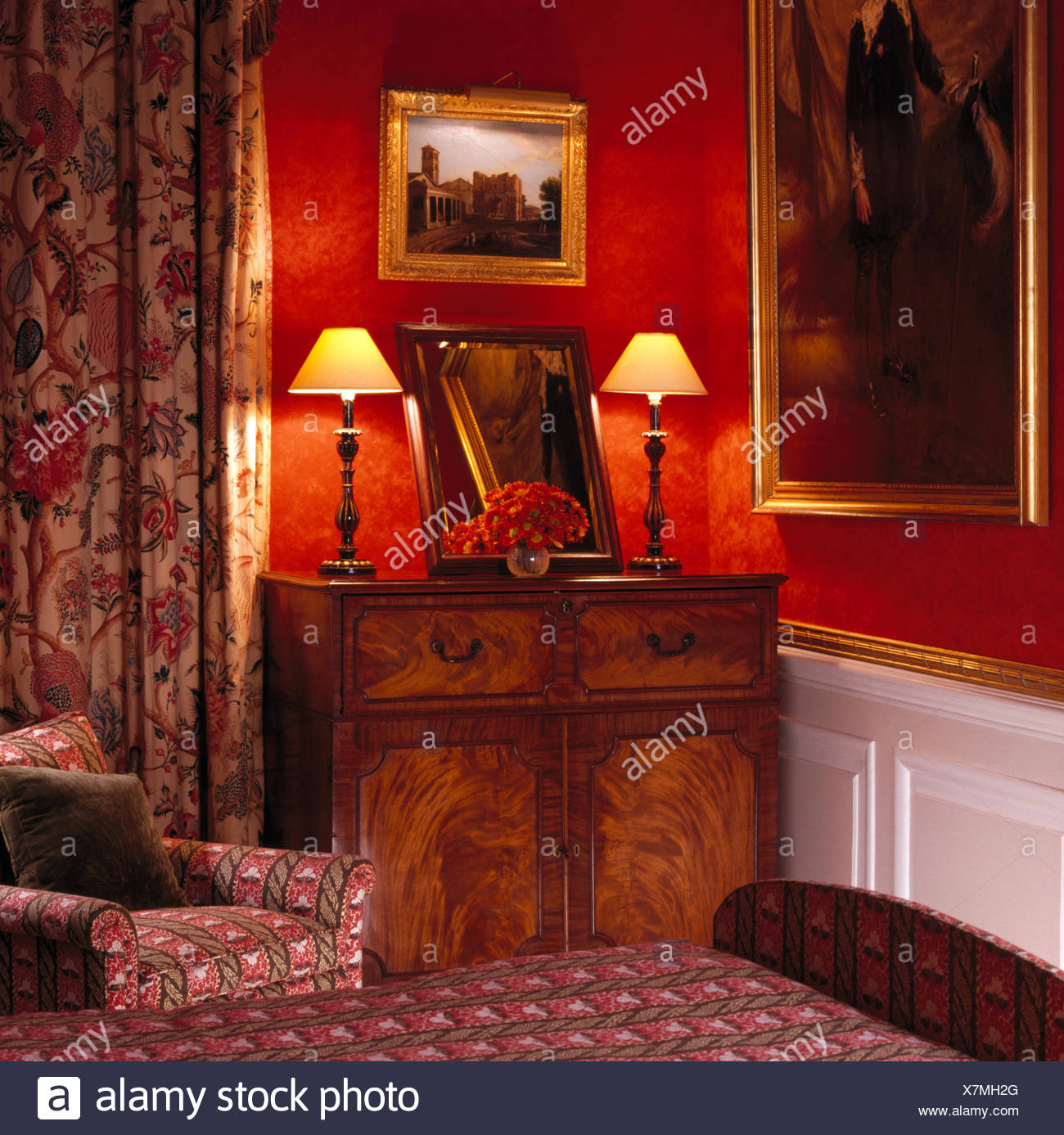 Lighted Lamps On Antique Cupboard In Red Nineties Bedroom