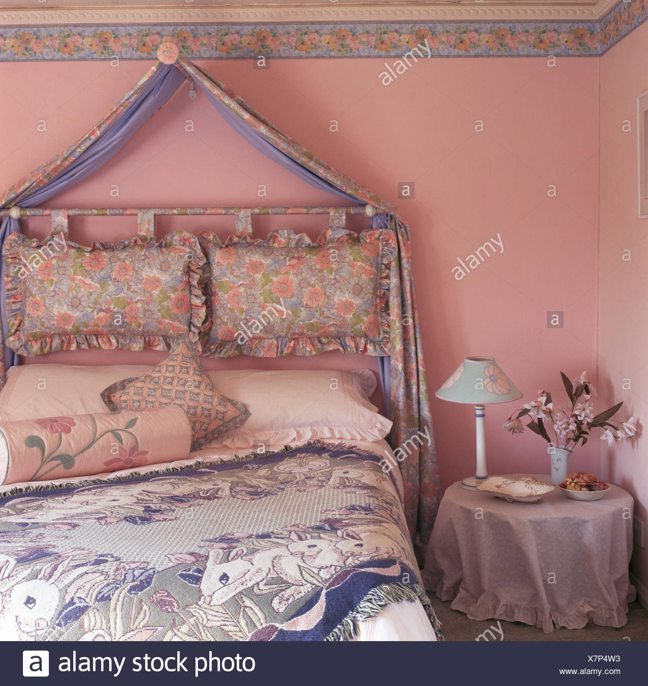 Draped Fabric Above Cushions Used As A Headboard On Wall Above Bed