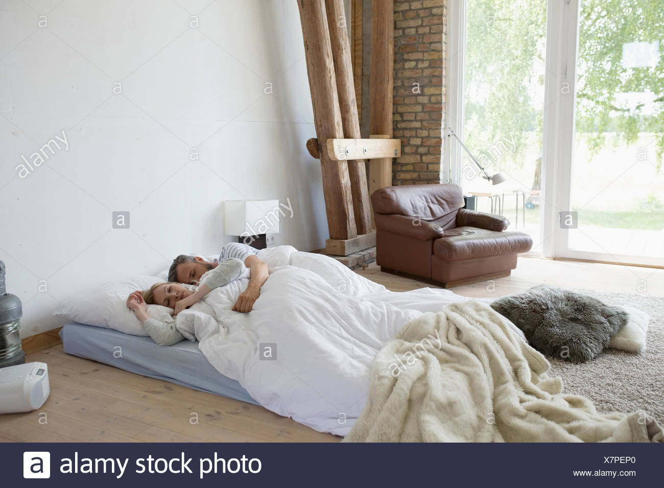 Serene Couple Sleeping On Bed Mattress On Bedroom Floor