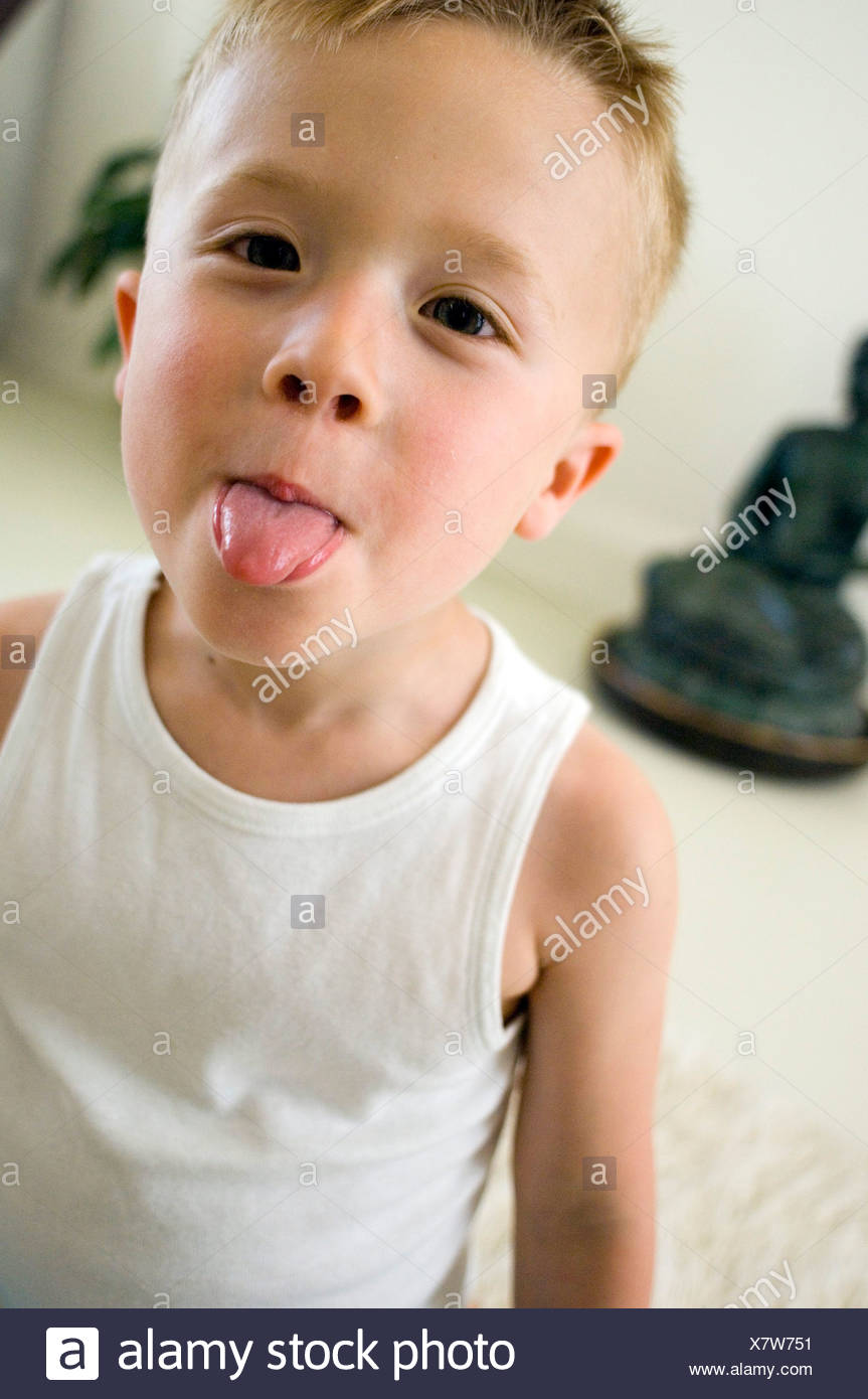 Male Child Blonde Hair White Vest Top Sticking Tongue Out Stock