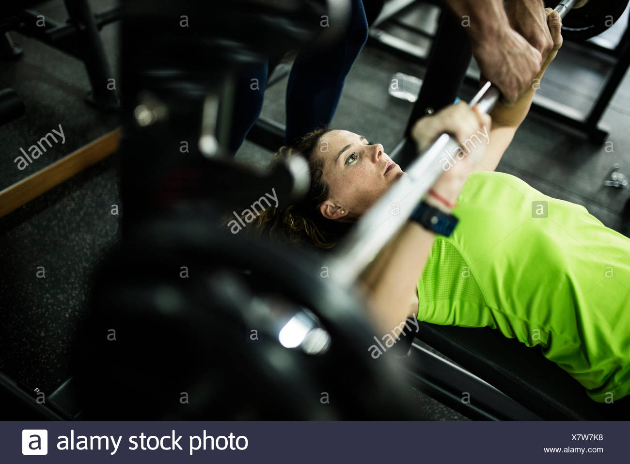 Woman Training Bench Press At Gym With Assistance Stock Photo