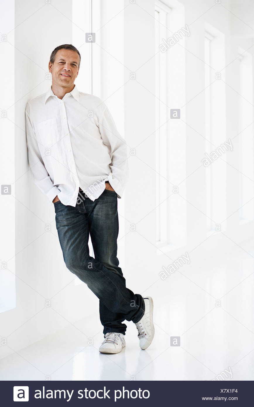 Smiling Man Leaning Against Wall Stock Photo Alamy