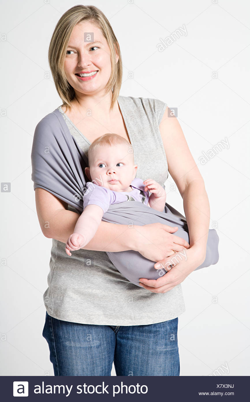 A mother carrying her baby in a sling 