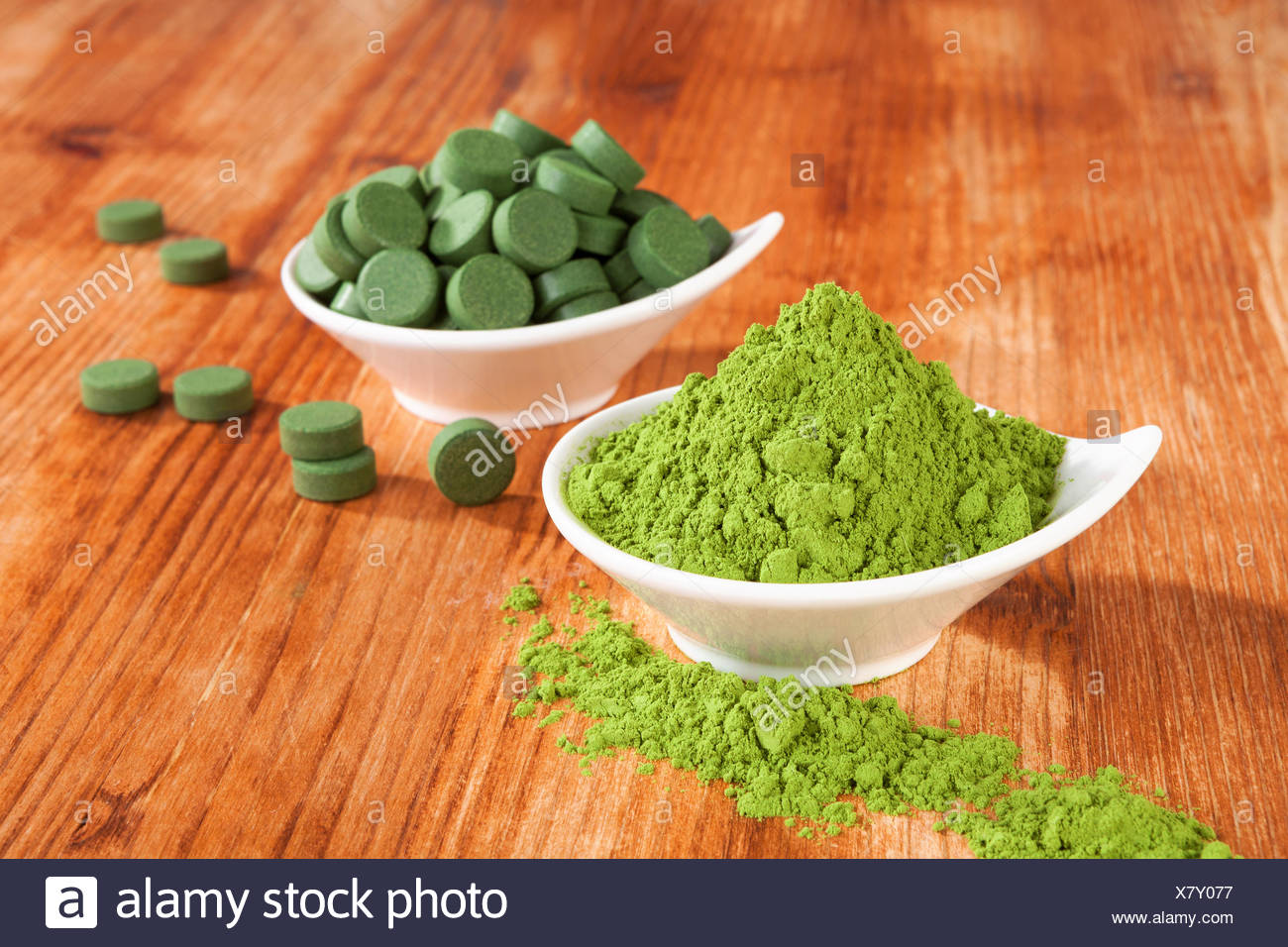 Detox Chlorella Pills And Wheat Grass Powder In Bowl On