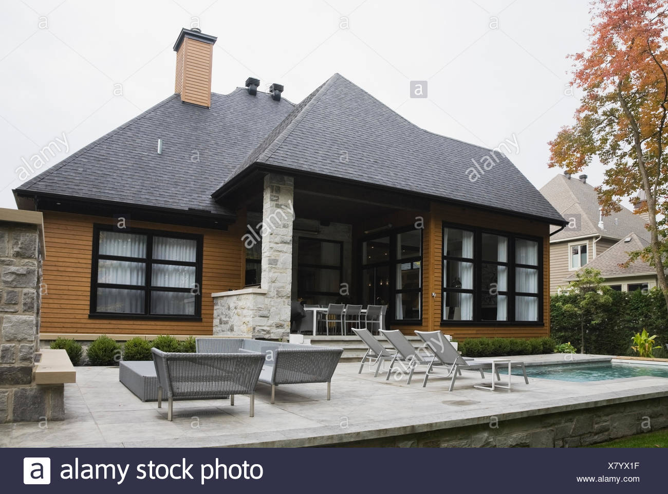 Rear View Of A Gray Stone Cottage Style Residential Home With