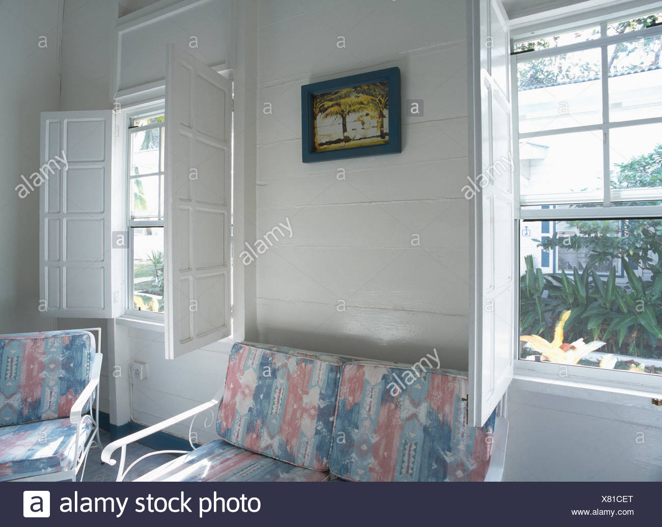 White Wooden Shutters On Windows In White Coastal Bedroom