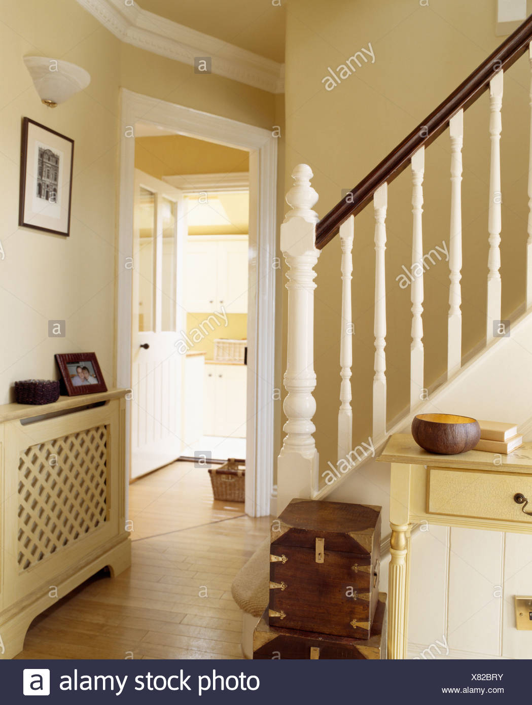 Fretwork Cover On Radiator In Traditional Cream Hall With Wooden