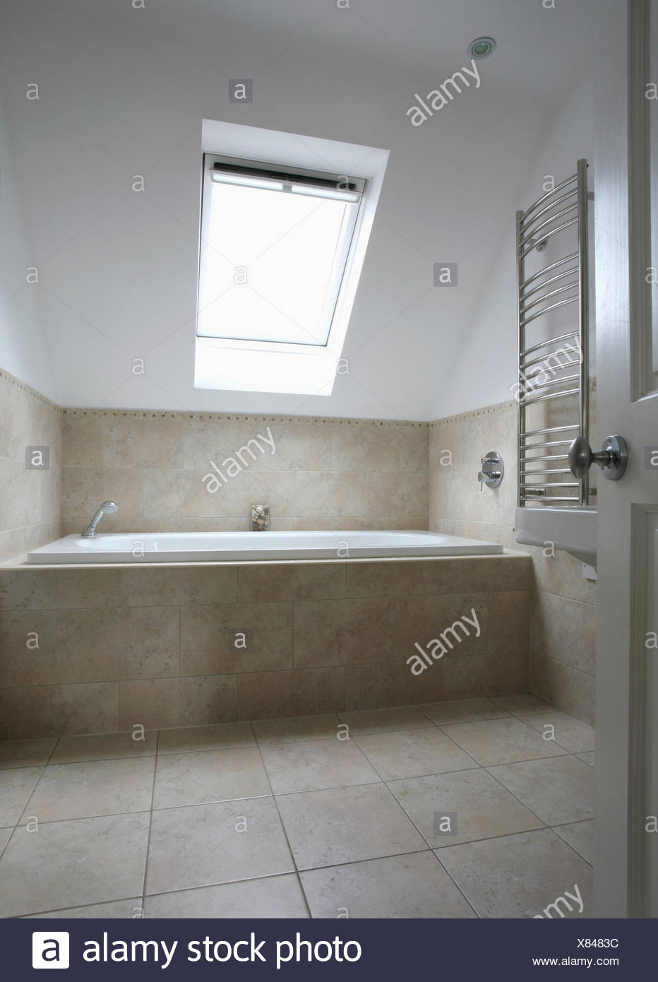 Velux Window In Modern Attic Bathroom With Limestone Floor Tiles