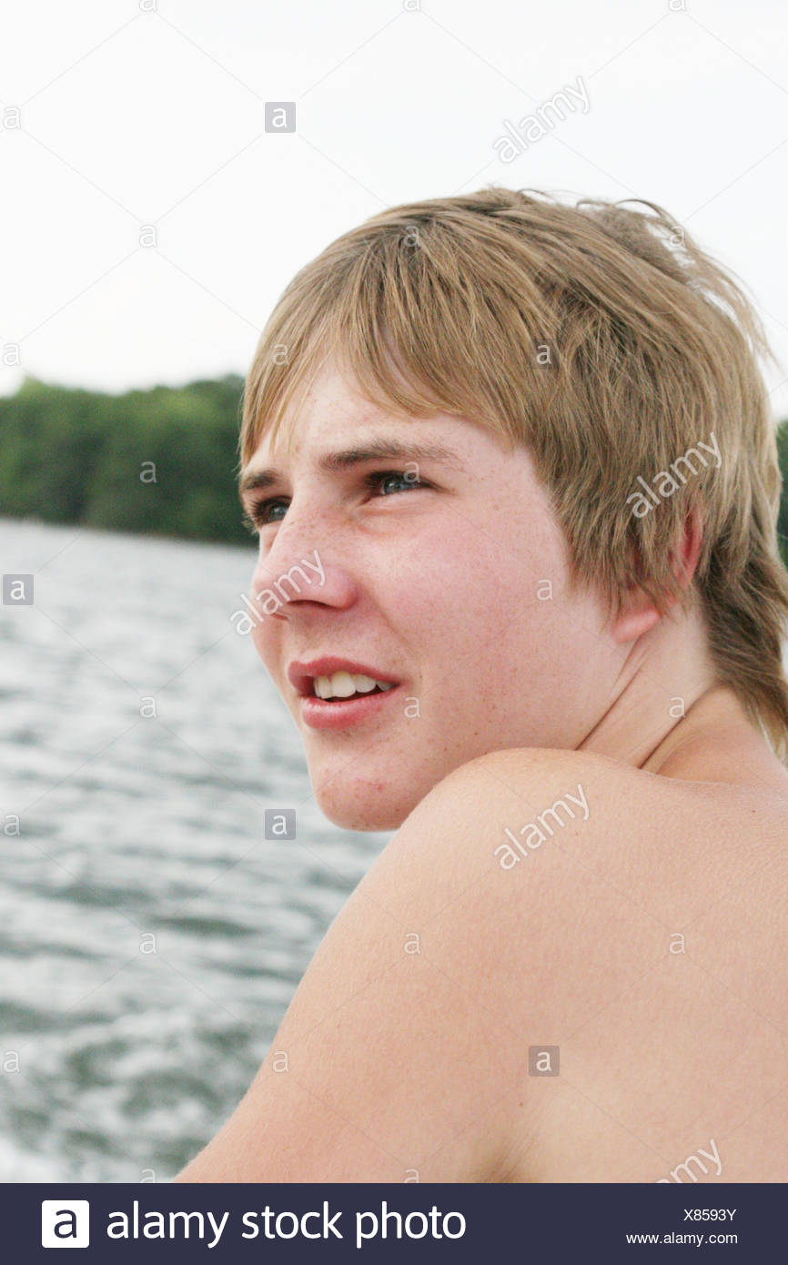 Teenage Male With Blonde Hair Unsmiling Looking To The Side