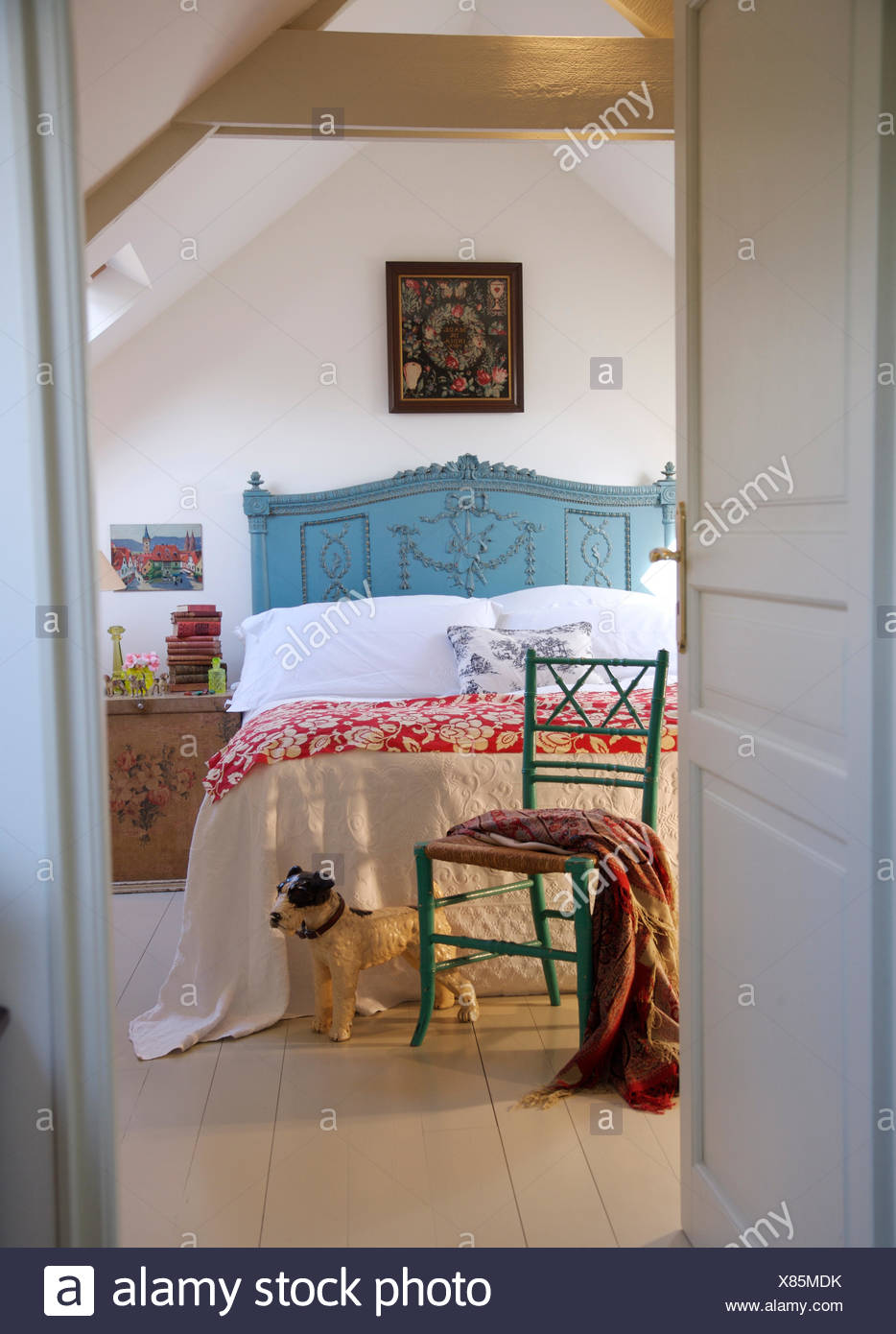View Through Door Of Blue Painted Bed With White Quilt And