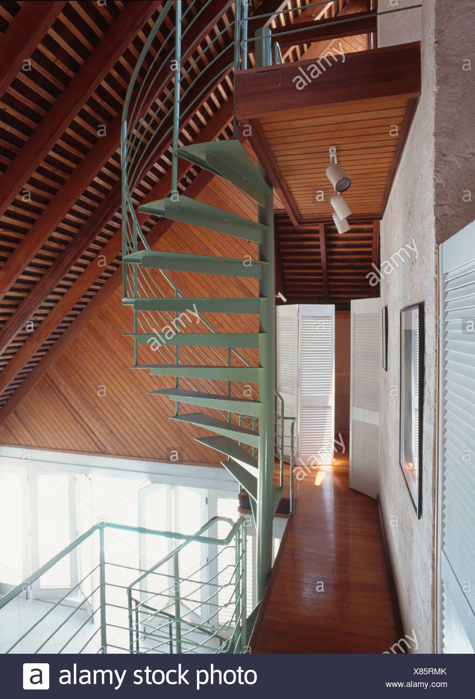Green Spiral Staircase And Wooden Flooring On Landing Below