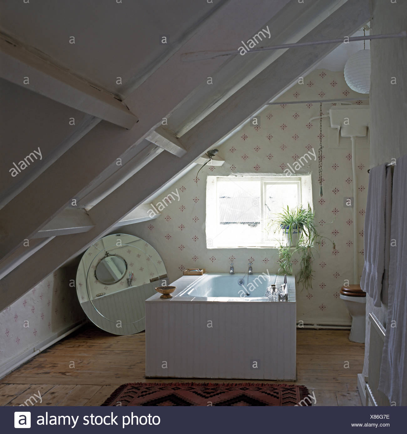 White Painted Beams In Attic Bathroom With A Central Bath And A