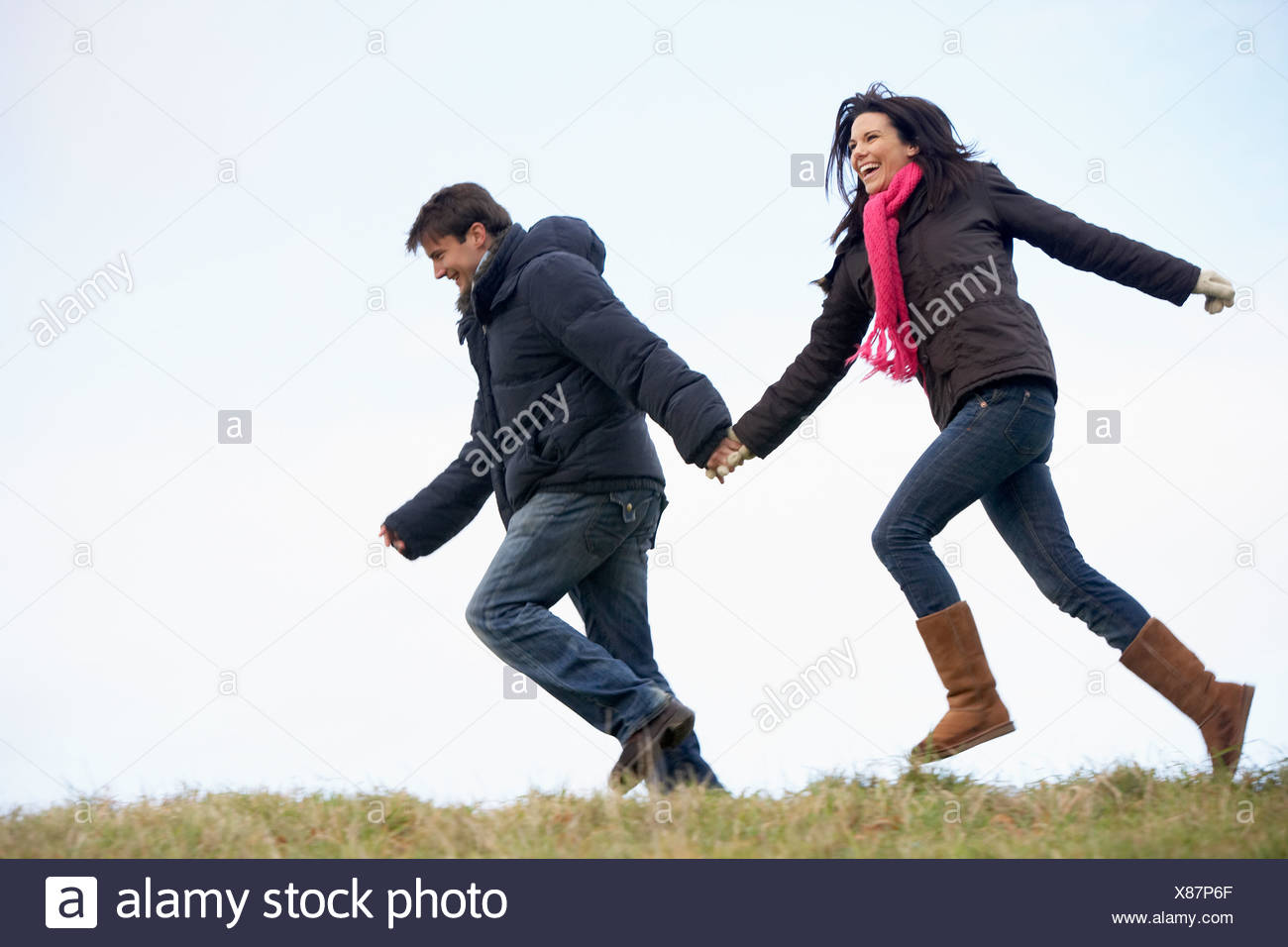 pics Couple Running Together Holding Hands https www alamy com couple holding hands and running in the park image280454231 html
