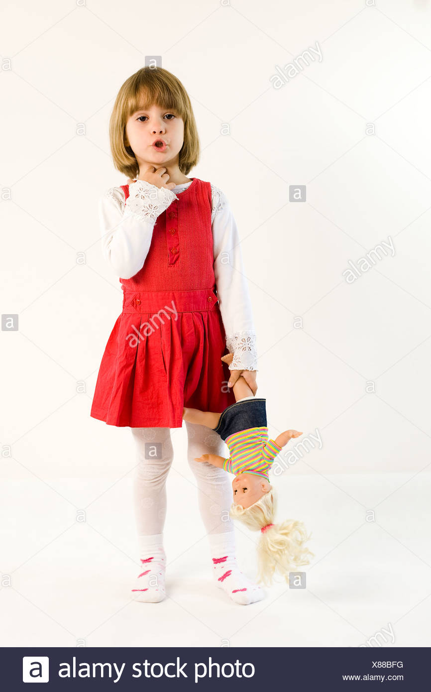 little girl holding doll
