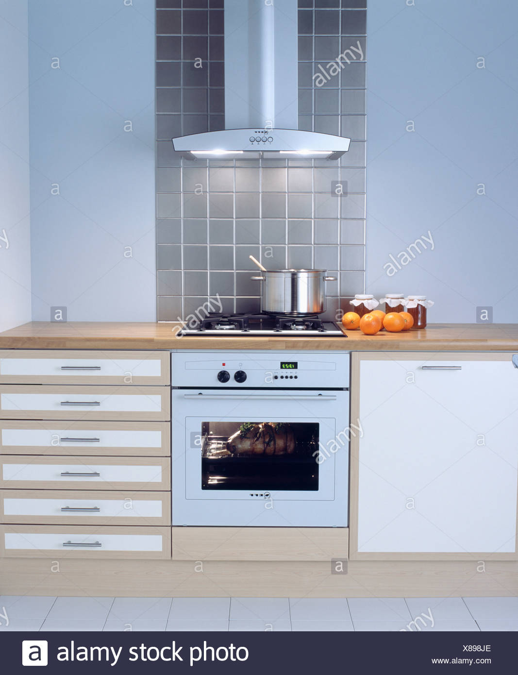 Extractor Fan Above White Oven In Modern White Kitchen With Storage Drawers Stock Photo Alamy