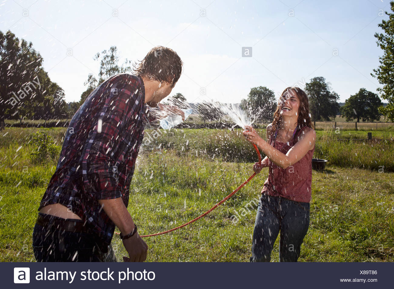 Girl Guy Hose On Field High Resolution Stock Photography and Images Alamy