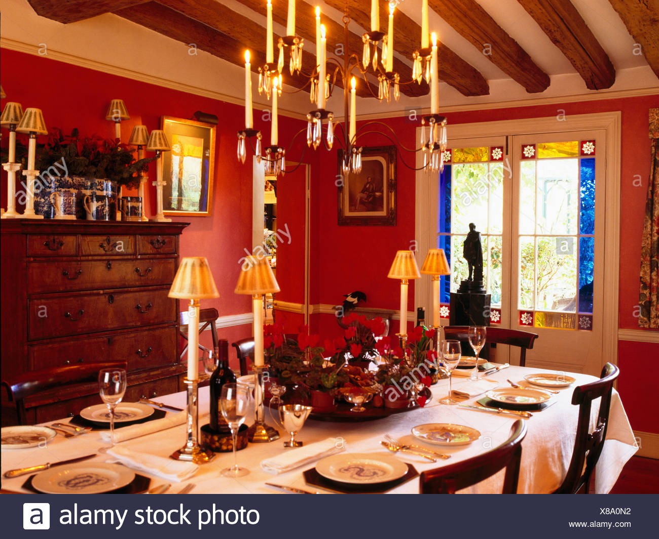 Lighted Candles In Chandelier Above Table Set For Lunch In
