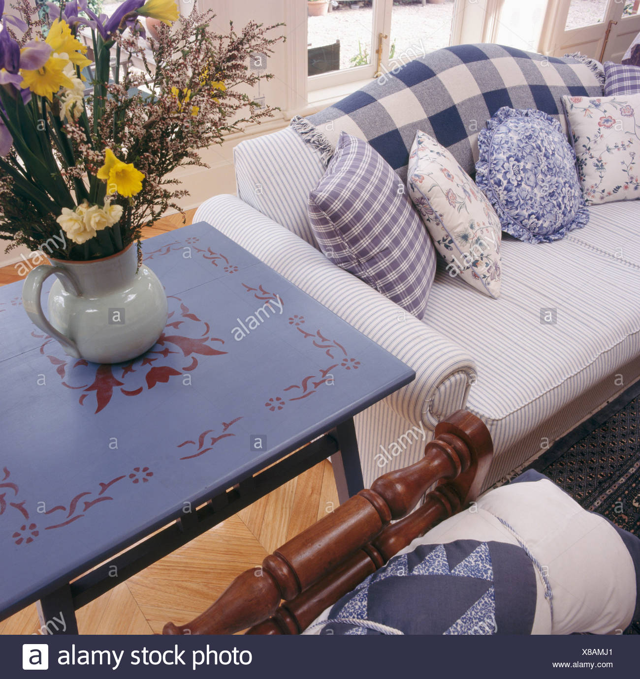 Painted Blue Table Beside Striped Sofa With Blue White Checked And
