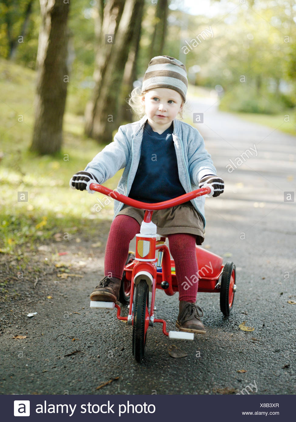 girl riding tricycle