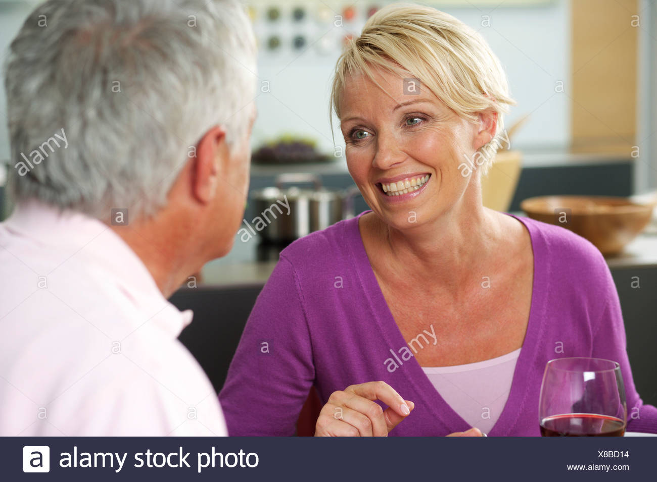 Blonde Woman And Gray Haired Man Having Dinner Close Up