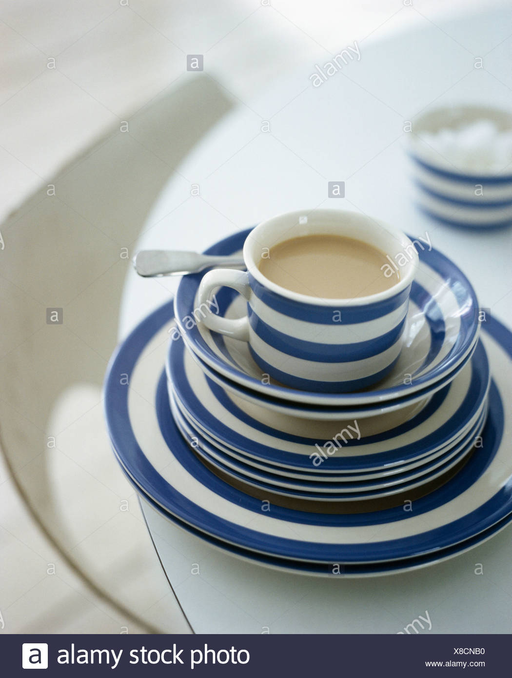 Close-up of blue+white striped Cornish-ware cup on stack of matching : cornish tableware - pezcame.com