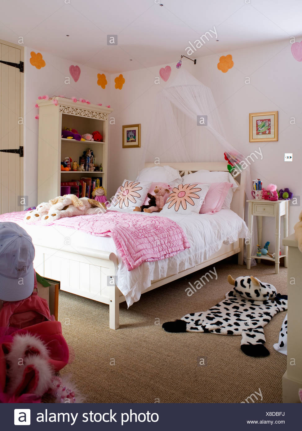 White Voile Drapes Above Bed With Pink Quilt In Girl S Bedroom