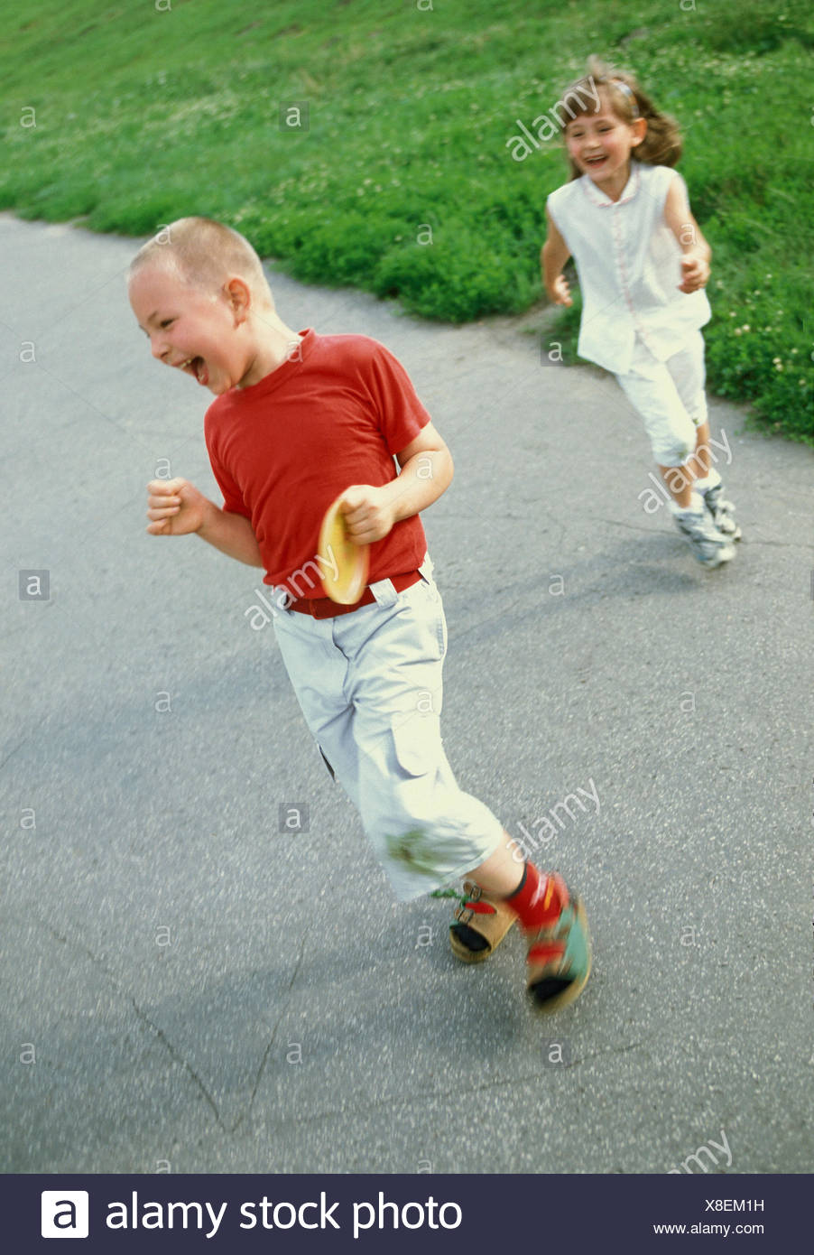 Two Young Children Playing Chase Stock Photos And Two Young Children