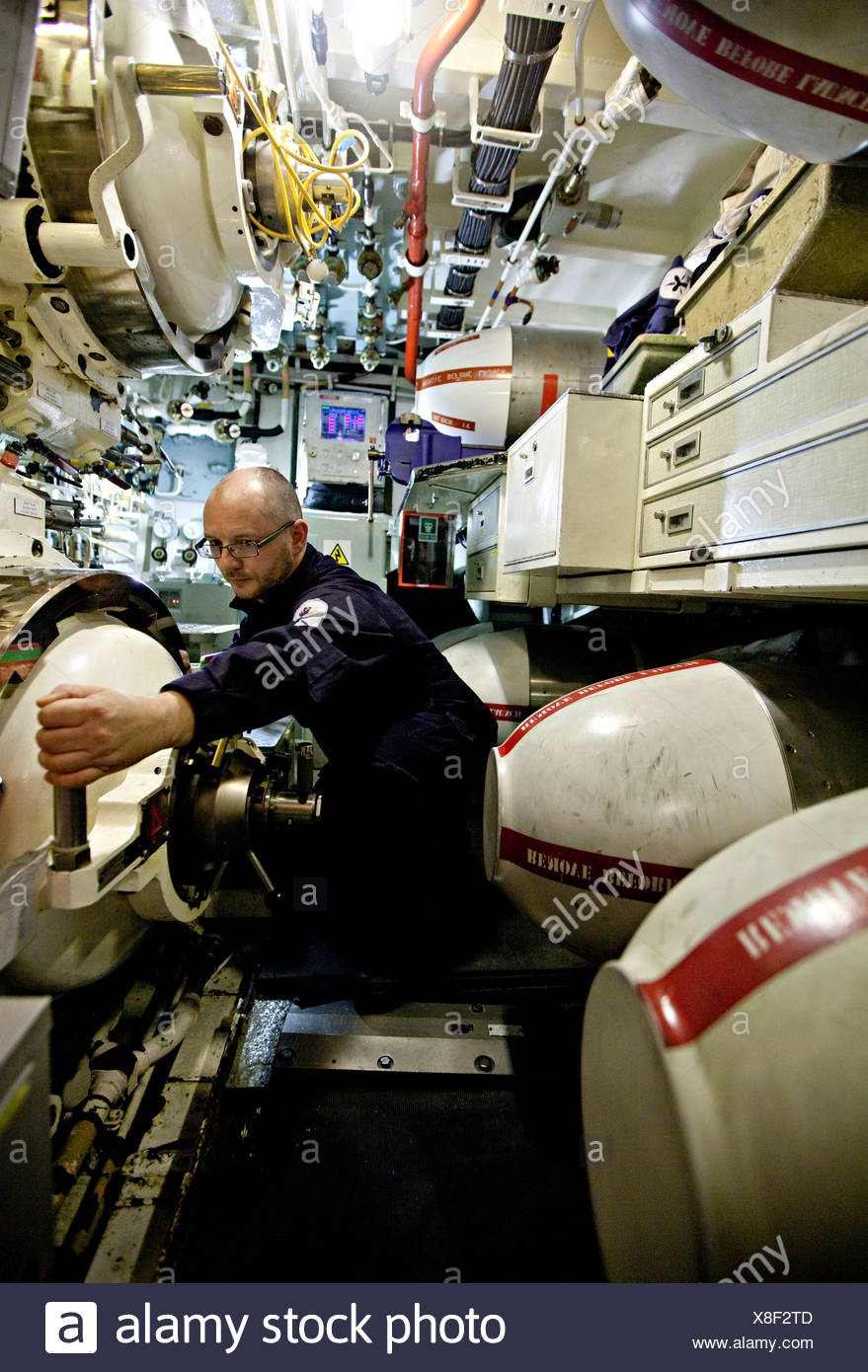 Crew Man With Hand On Lever In Torpedo Room Of Nuclear