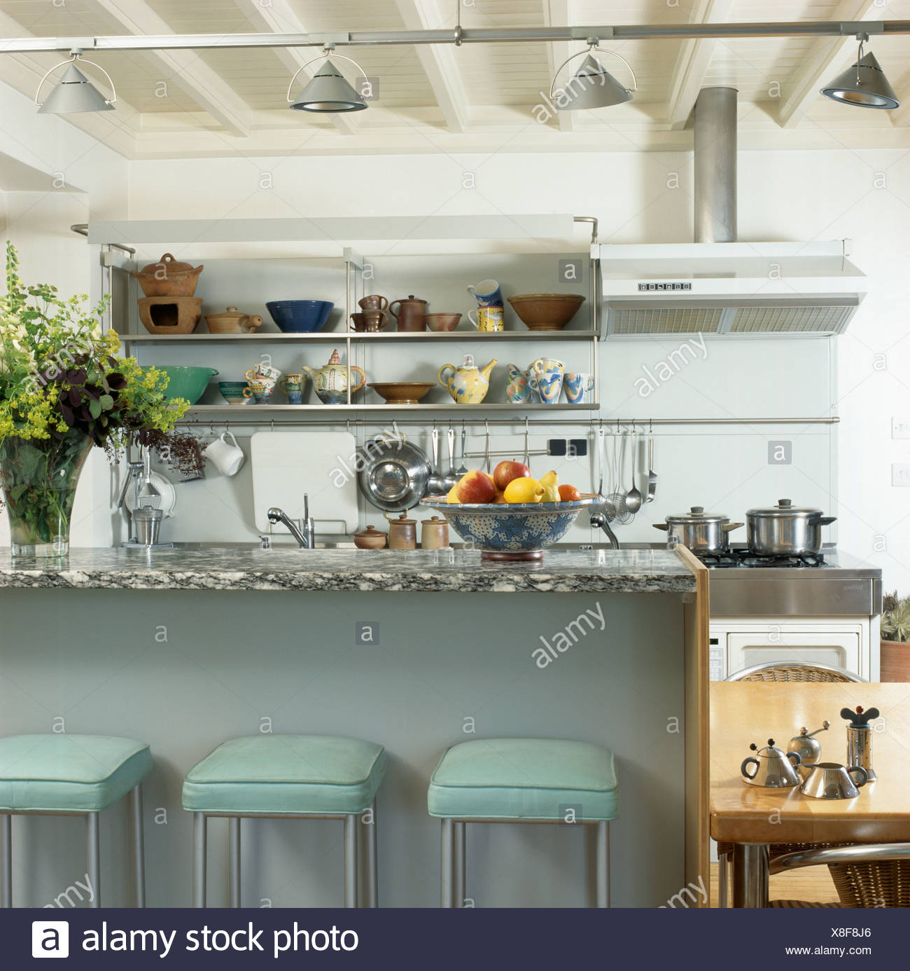 Green Stools At Breakfast Bar With Granite Worktop In Modern
