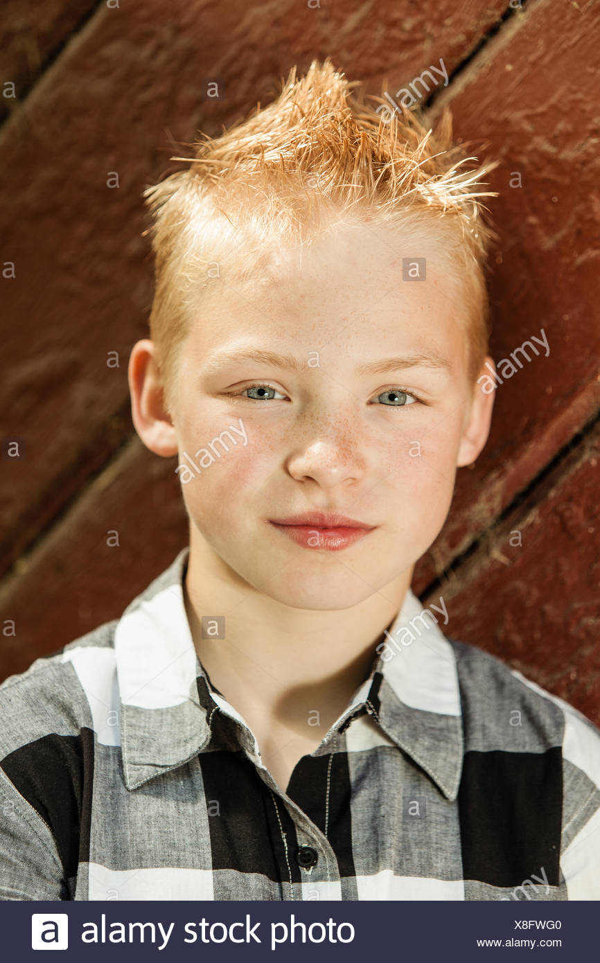Handsome Young Boy With A Cute Modern Hairstyle Stock Photo