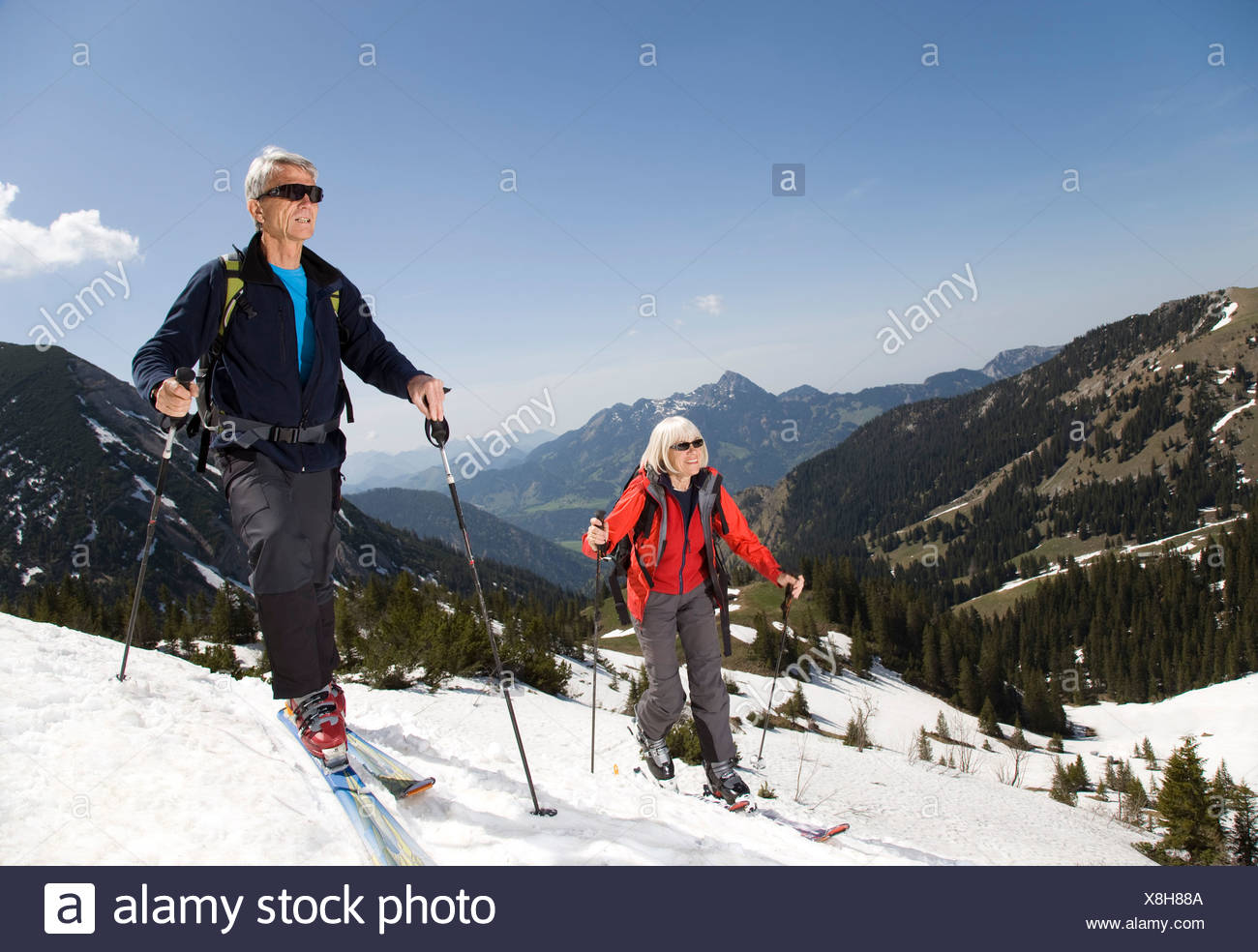 senior couple on ski tour in mountains Stock Photo
