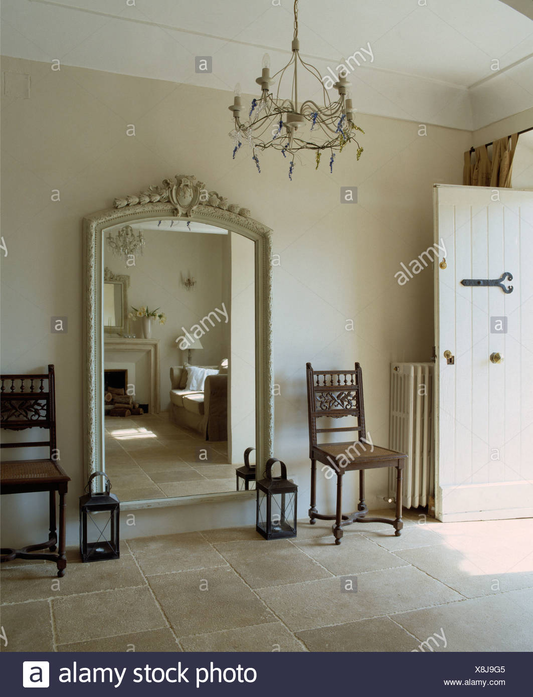 Large Cream Painted Carved Mirror On Wall Between Antique Rush