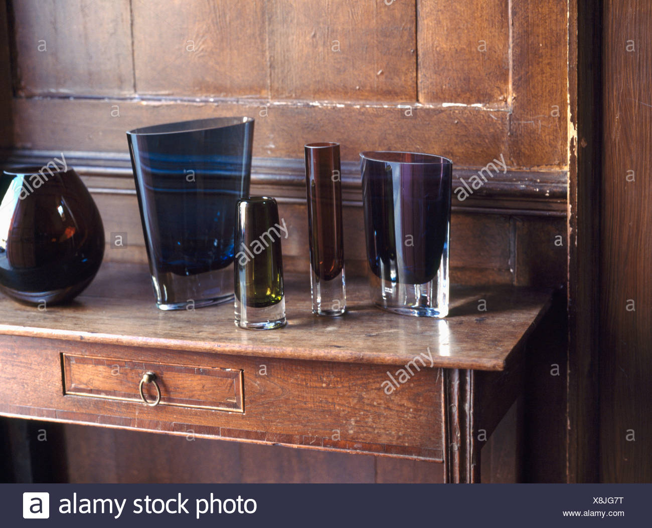 Close Up Of Collection Of Modern Lsa Brown Glass Vases On Antique