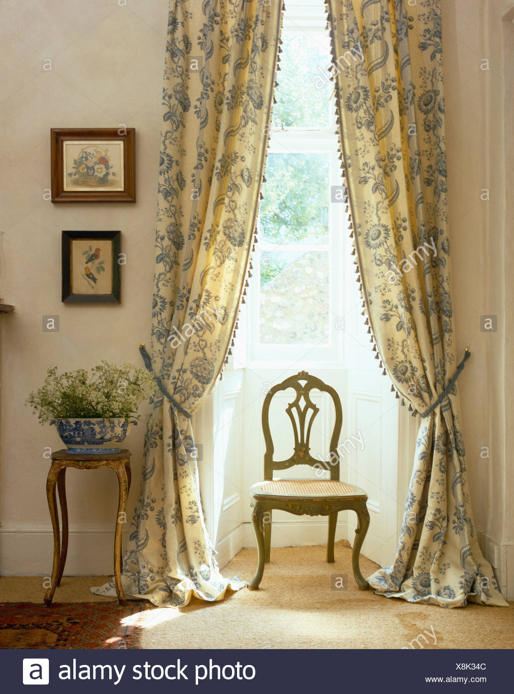 Antique Chair In Front Of Tall Window With Pastel Blue Patterned