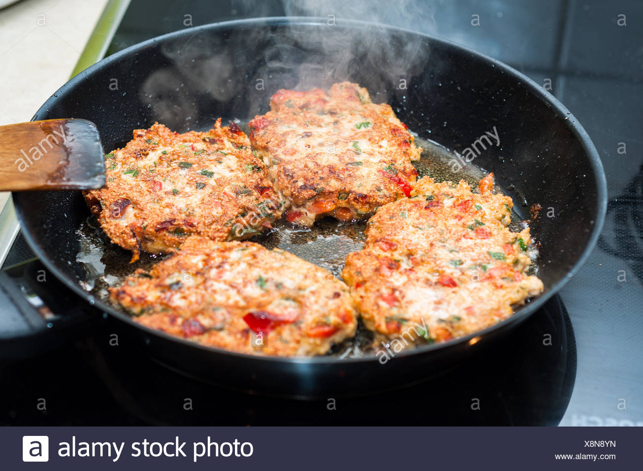 Cooking Home Made Meatballs With Vegetables In Pan On Ceramic