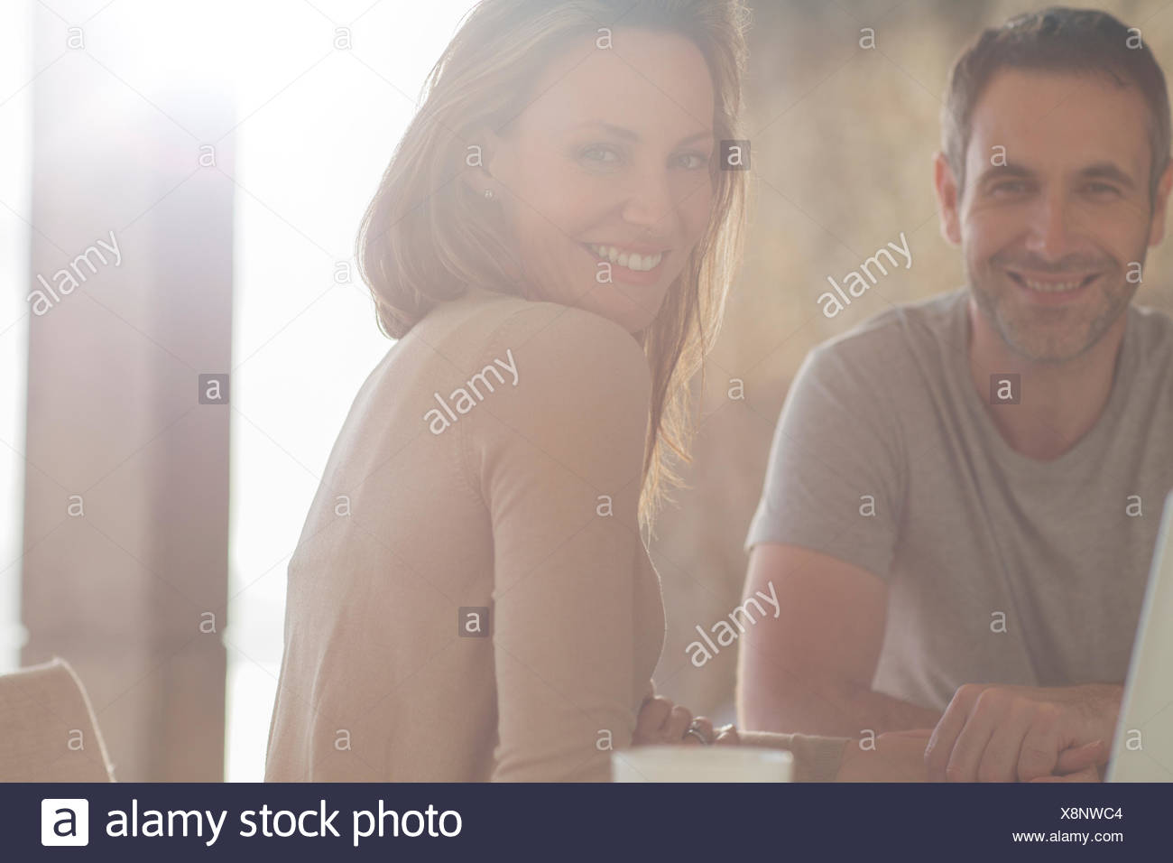 Couple smiling at breakfast table Stock Photo