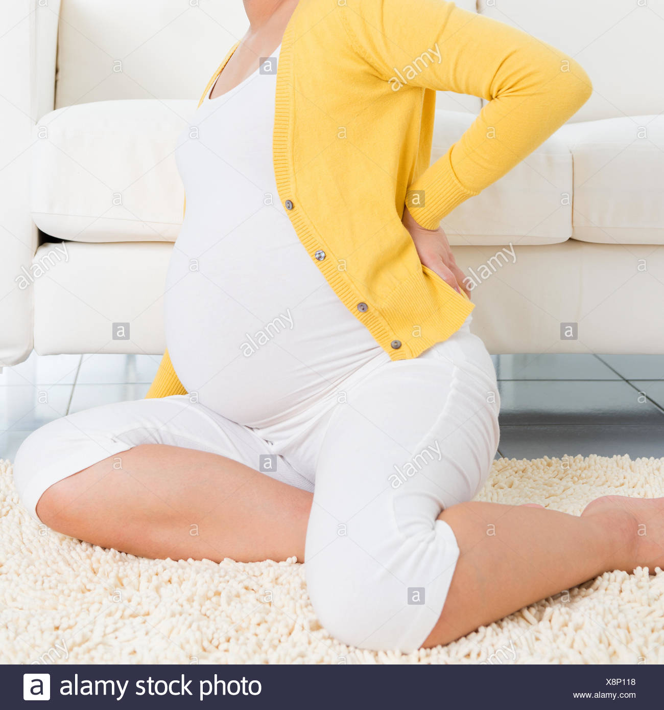 Back Pain 8 Months Pregnant Woman Holding Her Back While Sitting