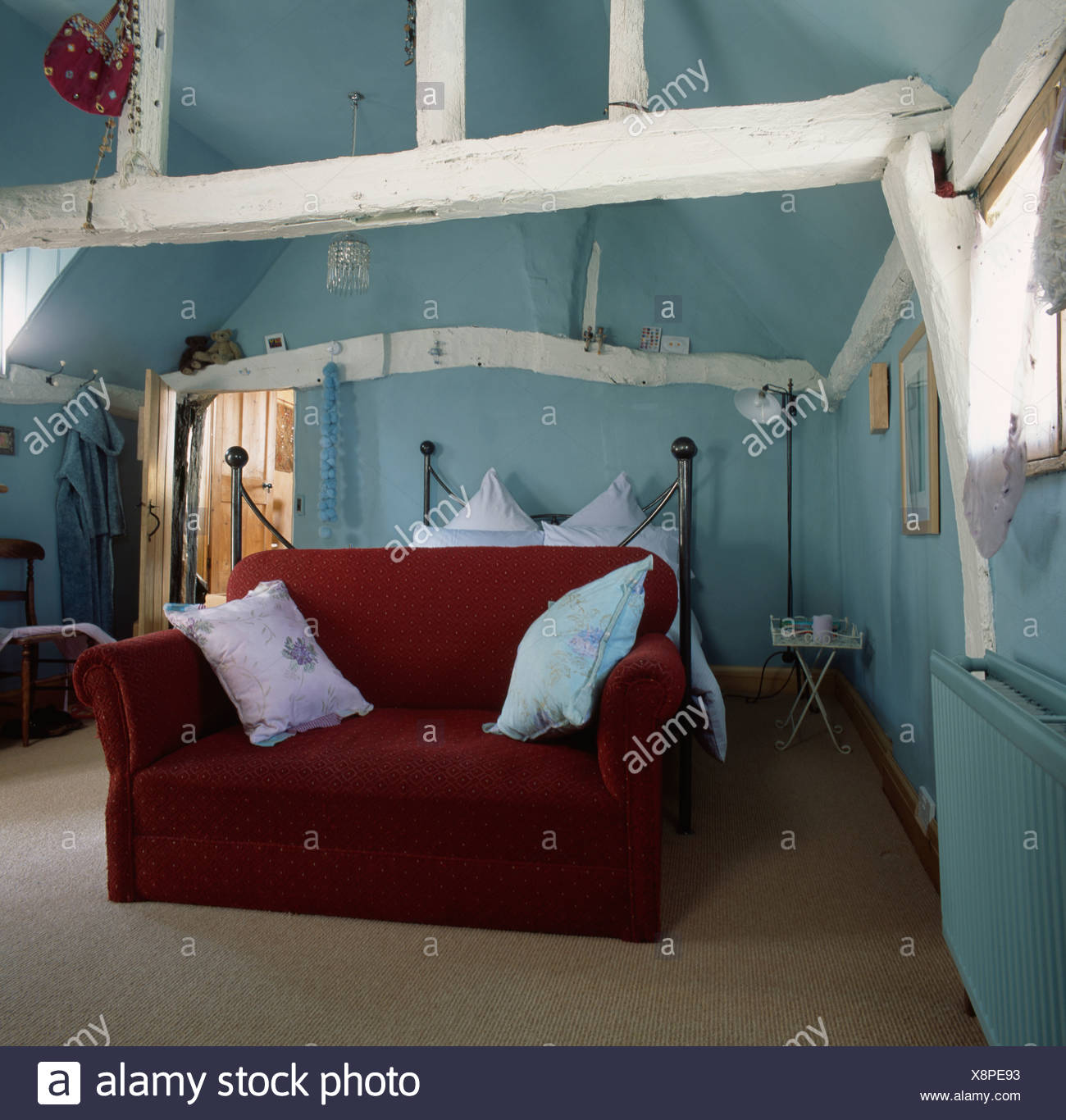 Red Velvet Sofa In Pastel Blue Attic Bedroom With White
