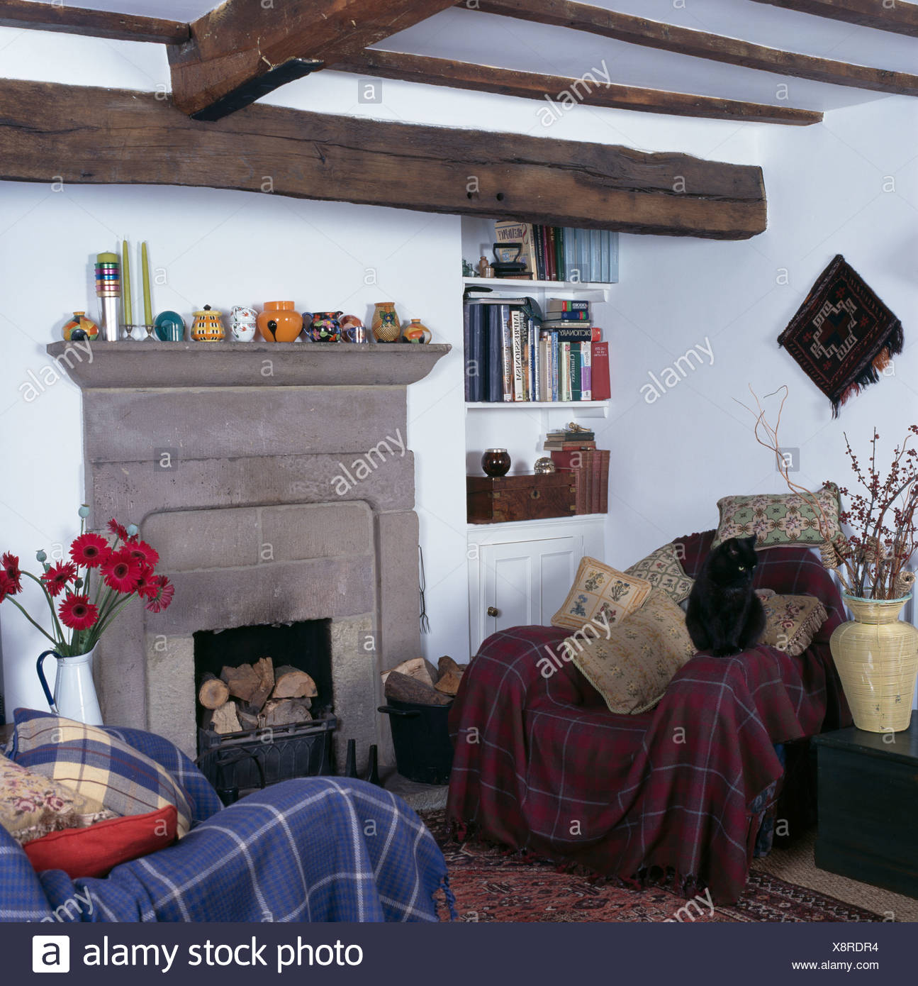 Tartan Throws On Armchairs On Either Side Of Stone Fireplace In