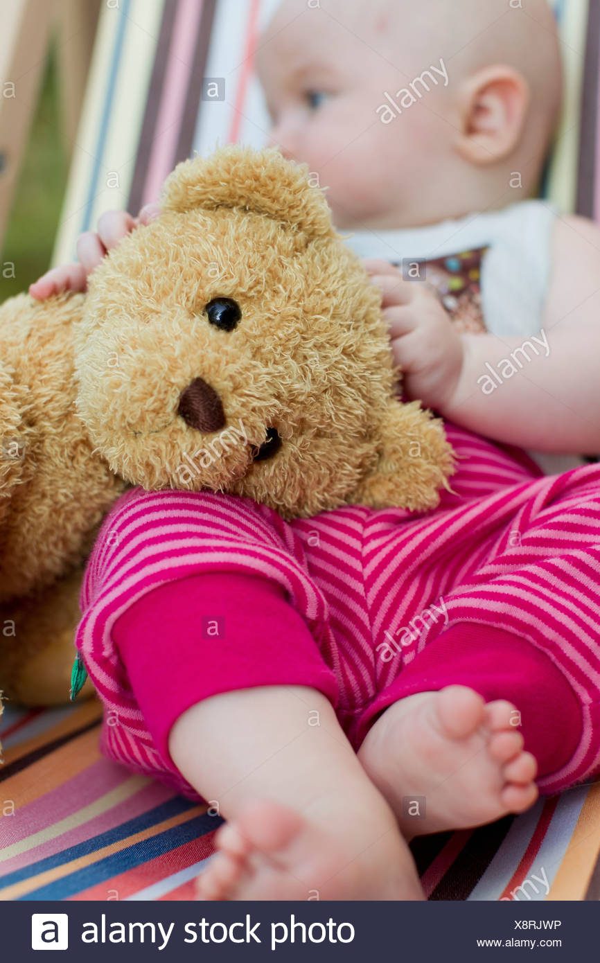 baby holding teddy bear