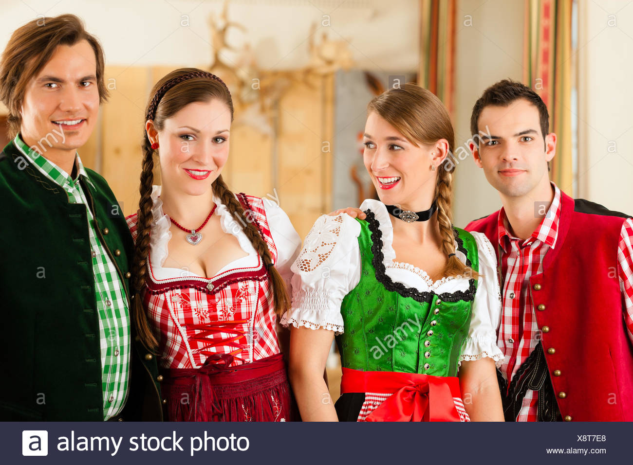 Young People In Traditional Bavarian Tracht In A Business Or - 
