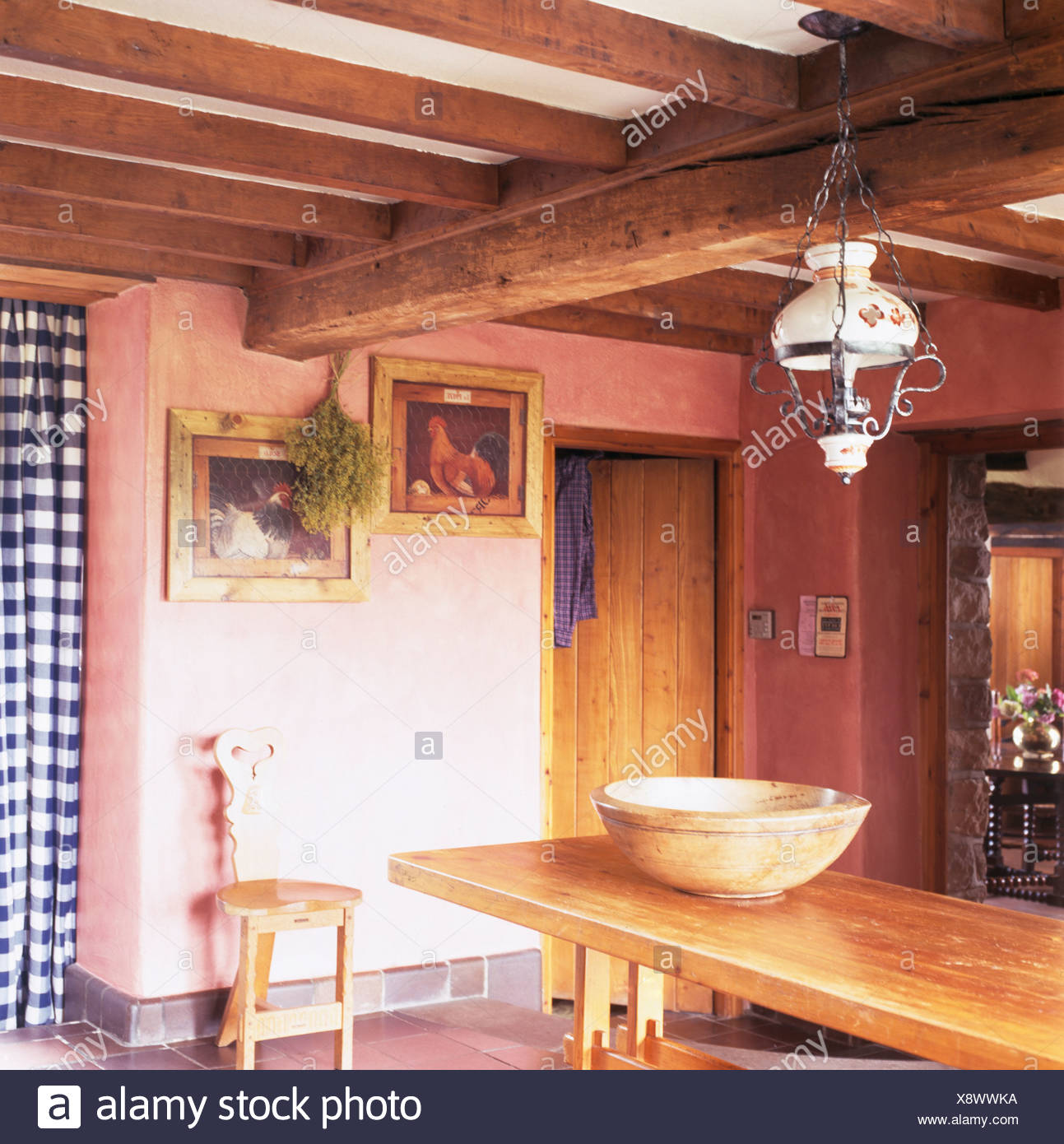 Victorian Glass Lamp Above Pine Table In Pink Cottage Dining