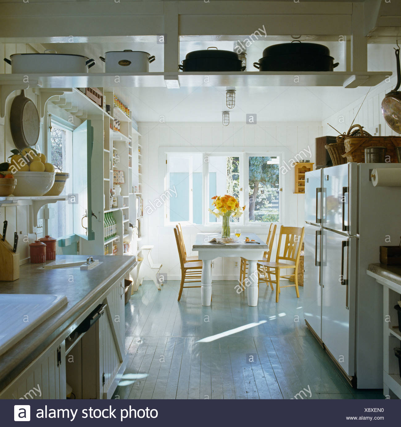 Shelves Suspended From The Ceiling In White Kitchen Dining