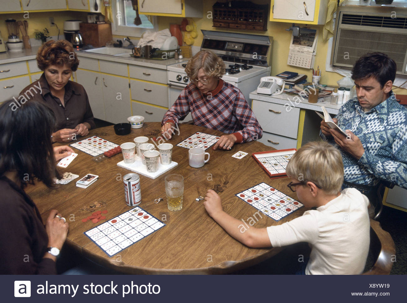 American Family Playing Board Game At The Kitchen Table Stock Photo Alamy